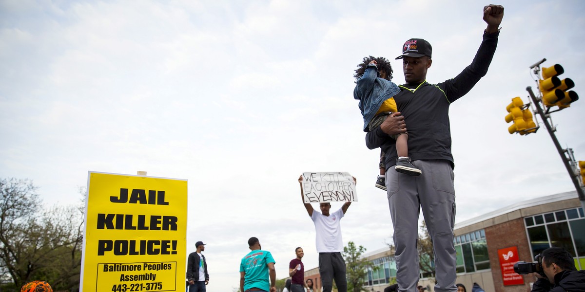 Demonstrators stand on top of vehicles at North and Pennsylvania avenues in Baltimore on May 1, 2015.