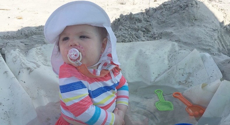 A baby enjoys playing in the shade while at the beach thanks to a DIY wading pool made by her parents.Jennifer Beck Goldblatt/Insider