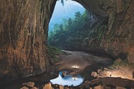 Cavers enter Hang En, a cave tunneled out by the Rao Thuong River.