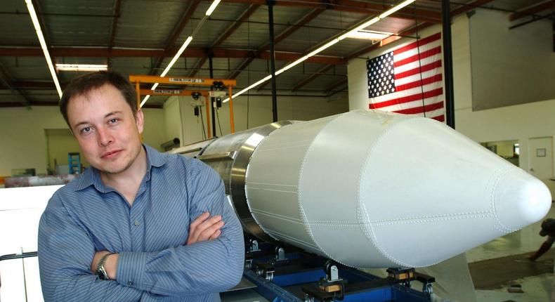 Elon Musk, the founder of SpaceX, stands beside a rocket in Los Angeles in 2004.