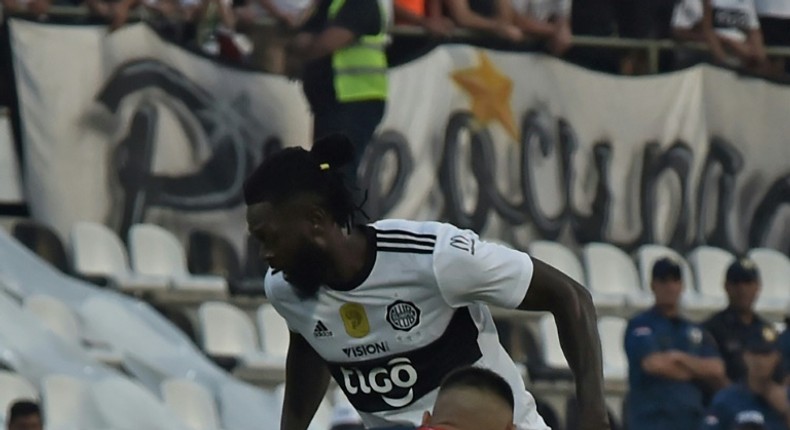 Adebayor (top) made his Olimpia debut on Sunday