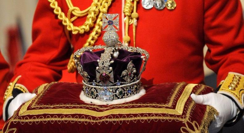The Imperial State Crown is carried in for Britain's Queen Elizabeth during the annual State Opening of Parliament