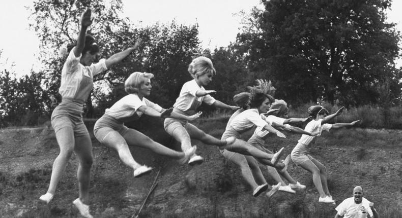 Cheerleaders training under Bill Horan, of the American Cheerleaders Assn.