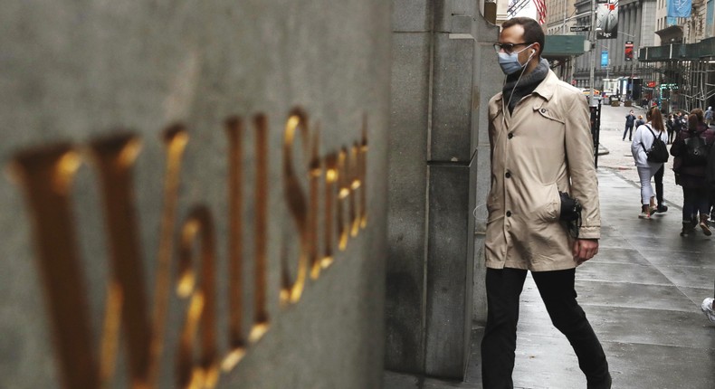 A man wears a protective mask as he walks on Wall Street during the coronavirus outbreak in New York.