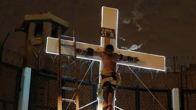 An inmate depicting Jesus performs the crucifixion scene in the theatre play Jesus Christ Superstar