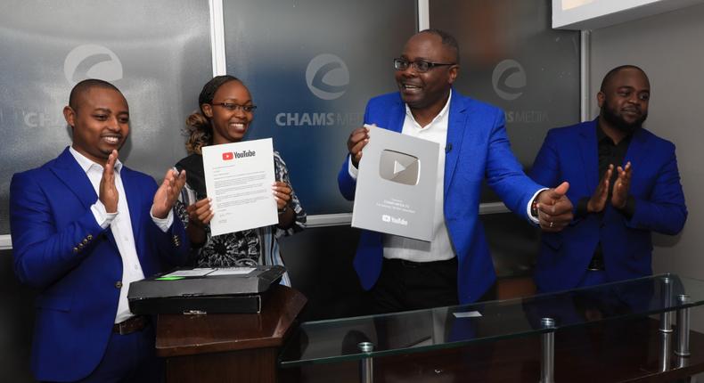 Alex Chamwada and his Chams Media Team after receiving the YouTube Silver Button