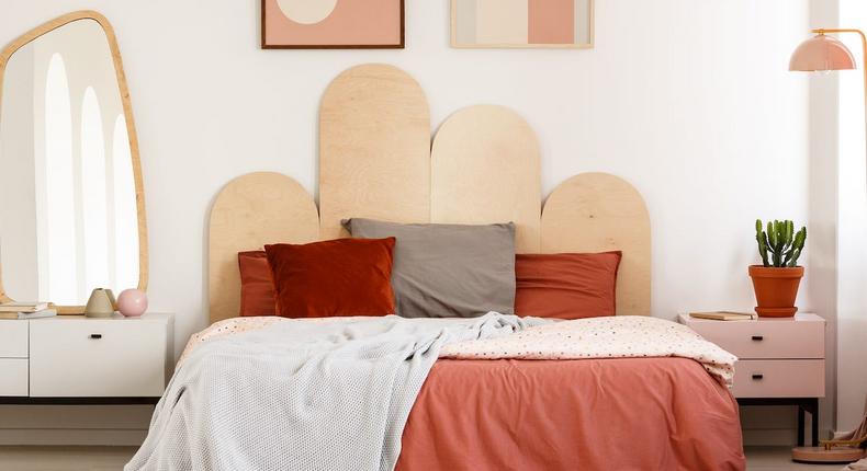 A tidy space and comfortable linens can make a bedroom even cozier. Ground Picture/Shutterstock