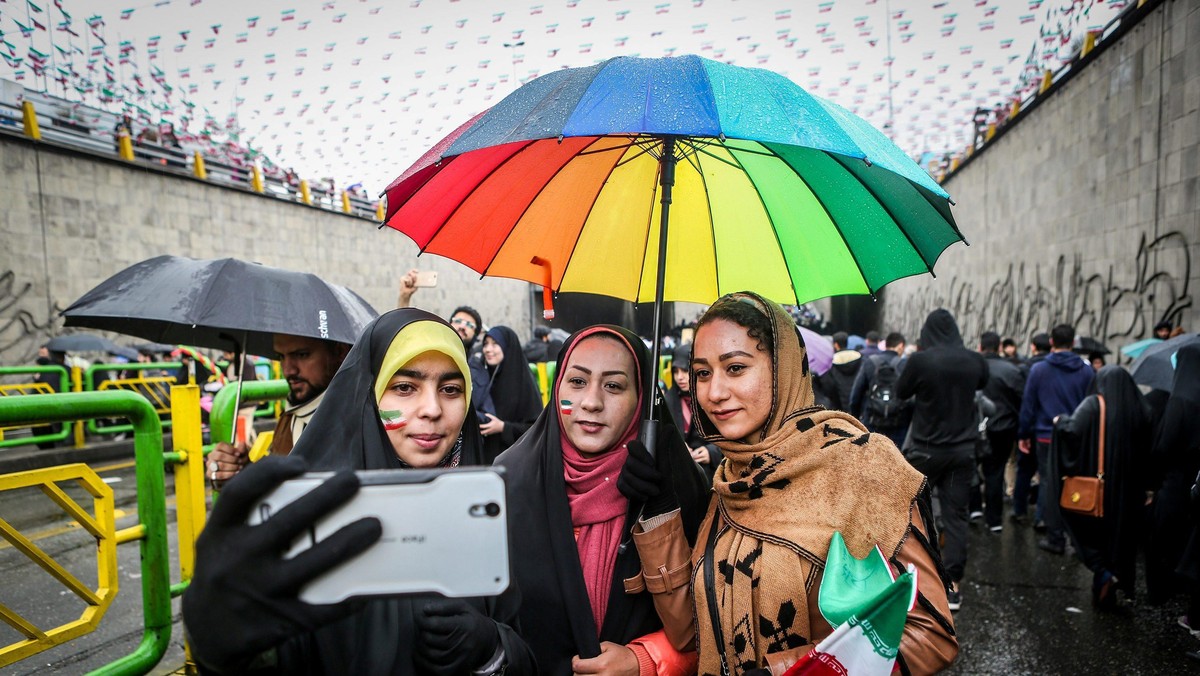 An Iranian woman take selfies during a ceremony to mark the 40th anniversary of the Islamic Revoluti