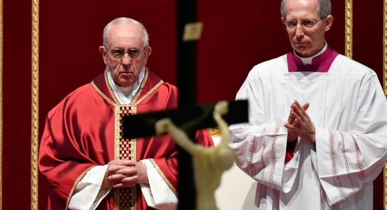 Pope Francis (L) presides over the Celebration of the Lord's Passion on Good Friday at St Peter's basilica, on April 14, 2017 in Vatican