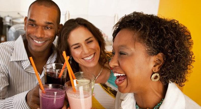 Black man and women drinking smoothies