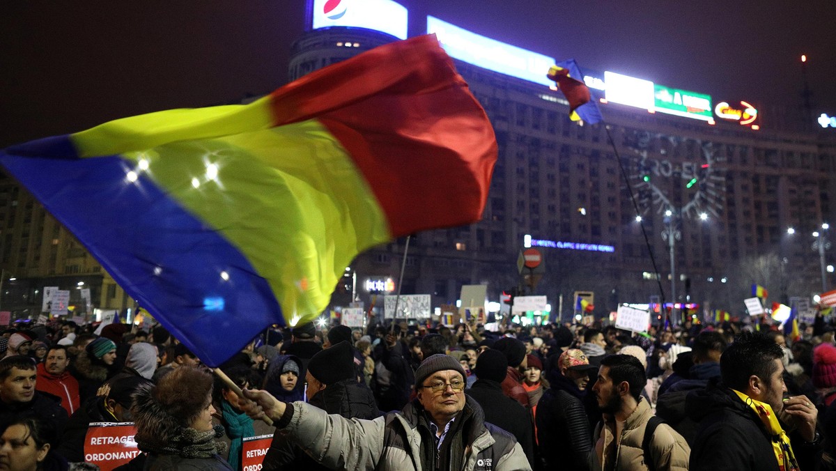 Protester waves Romanian flag during a demonstration in Bucharest