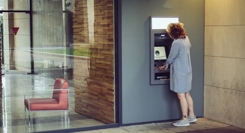 woman withdrawing cash from atm