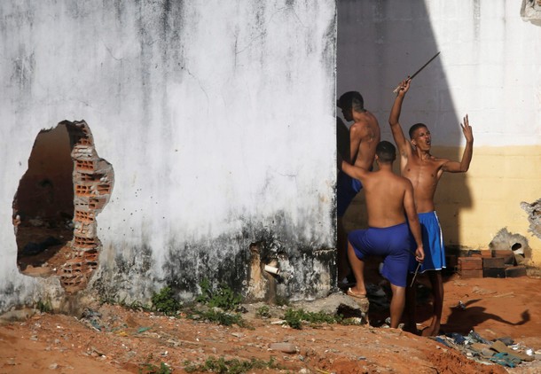 An inmate gestures after riot policemen did a head count of them during an uprising at Alcacuz priso