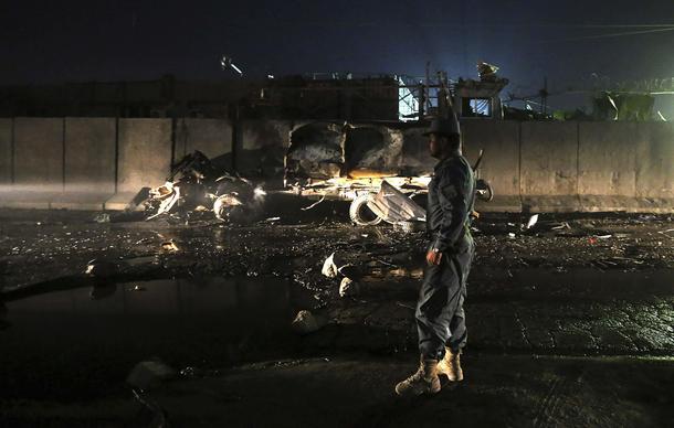An Afghan policeman keeps watch at the site of an attack in Kabul October 18, 2013. An attack involv