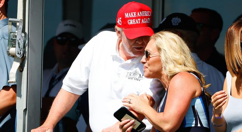 Former US President Donald Trump chats with Republican Rep Marjorie Taylor Greene of Georgia at the 16th tee during the second round of the LIV golf invitational series on July 30, 2022 in Bedminster, New Jersey.Rich Graessle/Icon Sportswire via Getty Images