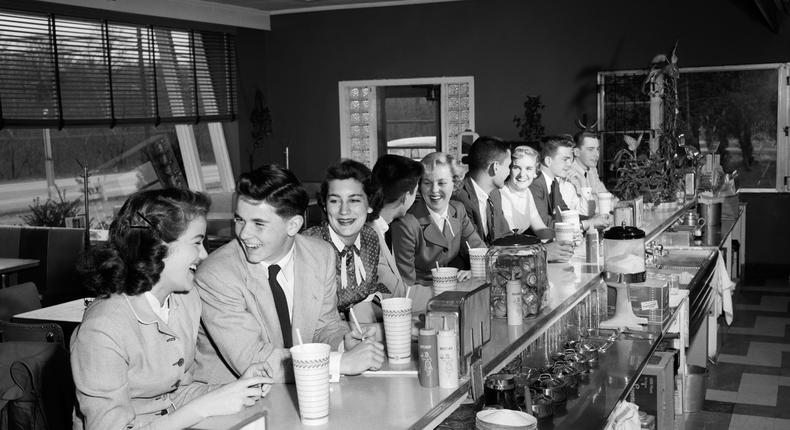 Teenagers sitting at a diner counter circa 1950.H. Armstrong Roberts/ClassicStock/Getty Images