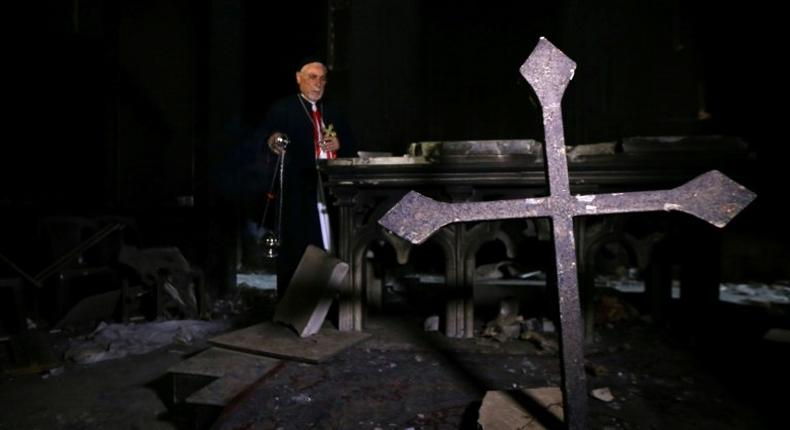 Archbishop Yohanna Petros Mouche of Mosul prays at the St. George Syriac Catholic Church in the Christian Iraqi town of Bartella, east of Mosul on October 30, 2016