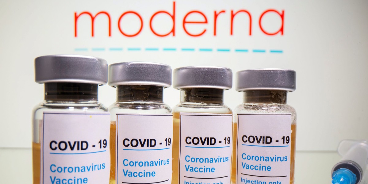 FILE PHOTO: Vials and medical syringe are seen in front of Moderna logo in this illustration