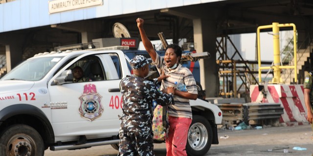 Police Task Force arresting a peaceful protester at the Lekki Toll Gate Plaza during the memorial event (TheCable)