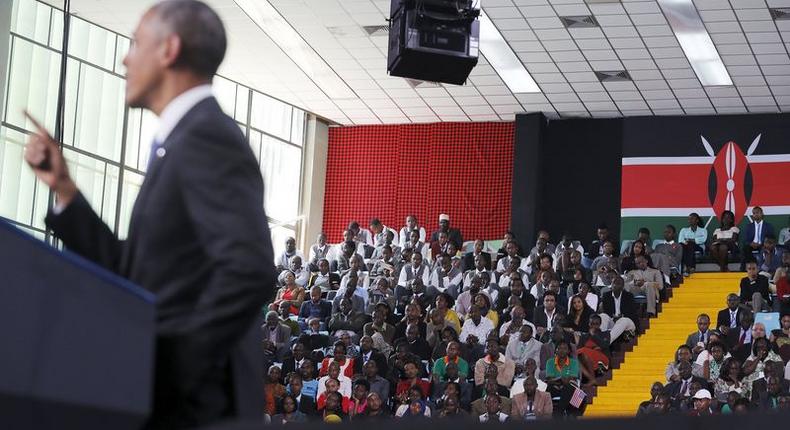 People listen as U.S. President Barack Obama delivers remarks at an indoor stadium in Nairobi July 26, 2015. Obama told Kenyans on Sunday on his first presidential trip to his father's homeland that there was no limit to what you can achieve but said they had to deepen democracy, tackle corruption and end exclusion based on gender or ethnicity. REUTERS/Jonathan Ernst