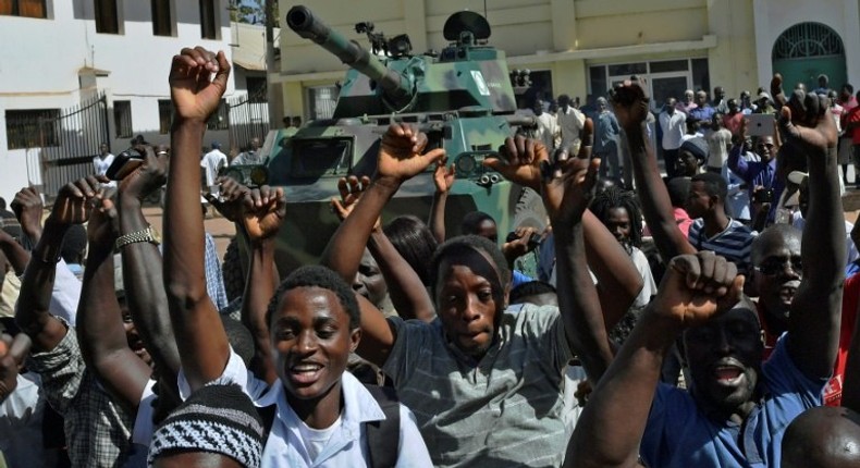 People celebrate in The Gambia's capital Banjul as the nation awaits the arrival of new President Adama Barrow