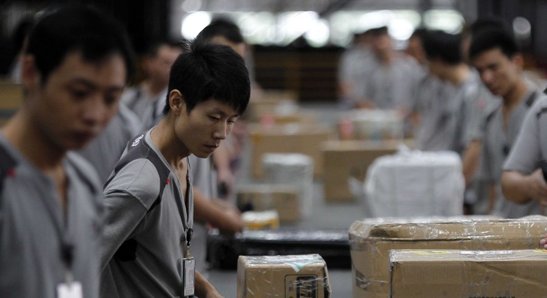 Chinese workers process packages for Alibaba sales (among others).