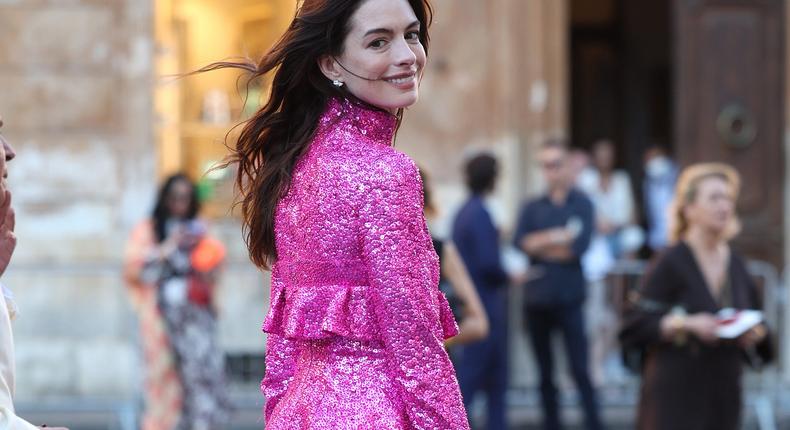 Anne Hathaway's outfit at the Valentino Haute Couture Fall/Winter 2022-2023 fashion show in Milan highlights Barbiecore's global reach.