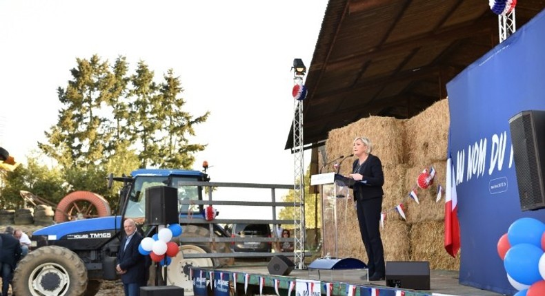 French presidential election candidate for the far-right Front National (FN) party Marine Le Pen (R) delivers a speech during a campaing rally at the Puybonnieux farm in Pageas, near Limoges, on April 13, 2017