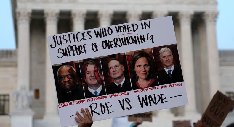 An activist holds up a sign during a rally in front of the U.S. Supreme Court in response to the leaked Supreme Court draft decision to overturn Roe v. Wade May 3, 2022.Alex Wong/Getty Images