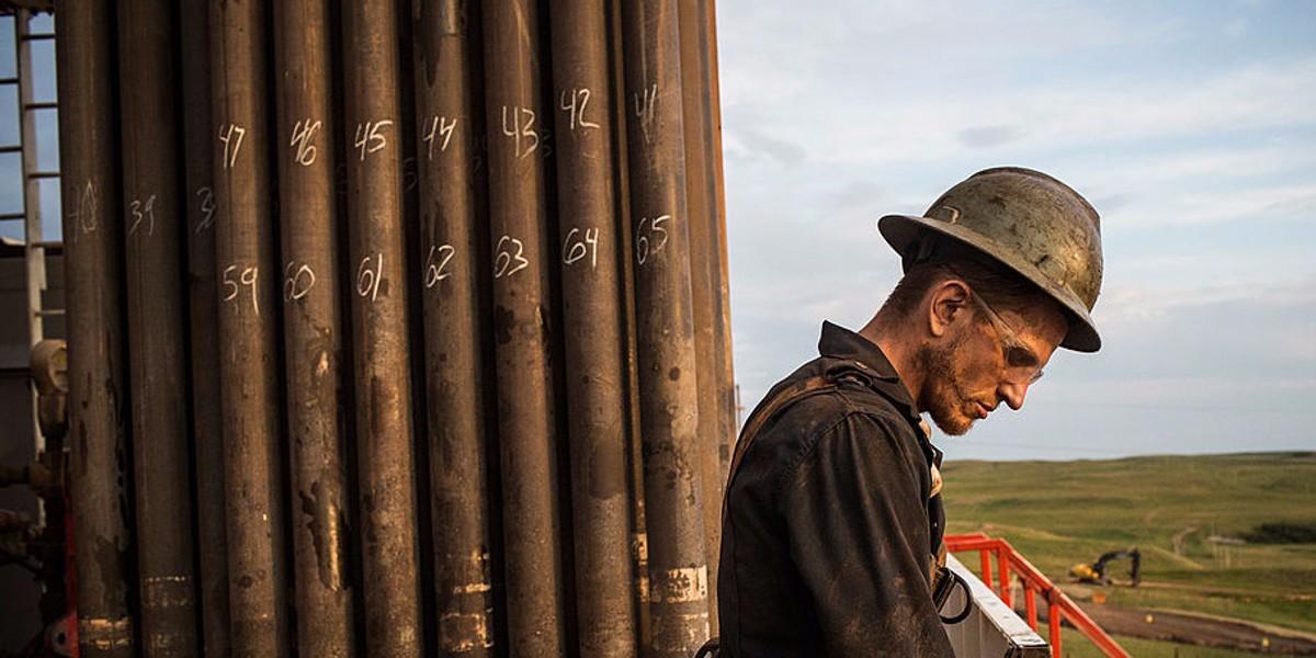 Ray Gerish, a floor hand for Raven Drilling, works on an oil rig drilling into the Bakken shale formation on July 28, 2013 outside Watford City, North Dakota.