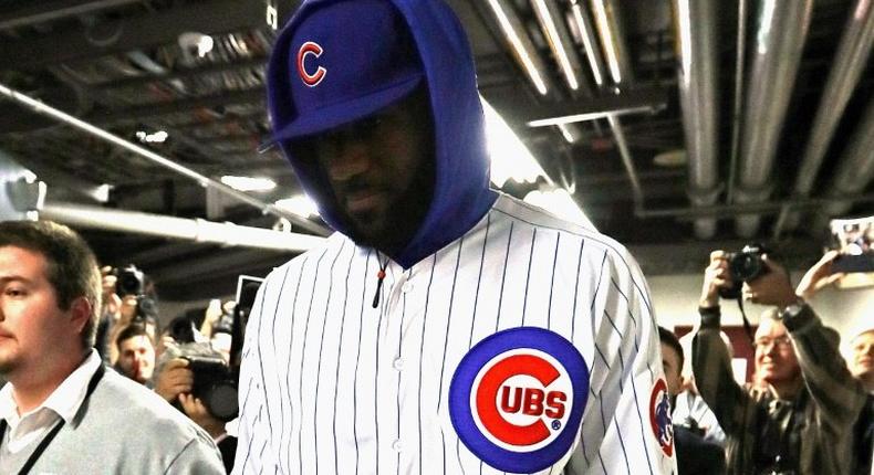 LeBron James #23 of the Cleveland Cavaliers enters the United Center in a Chicago Cubs uniform after losing a World Series bet with Dwyane Wade of the Chicago Bulls on December 2, 2016 in Chicago, Illinois