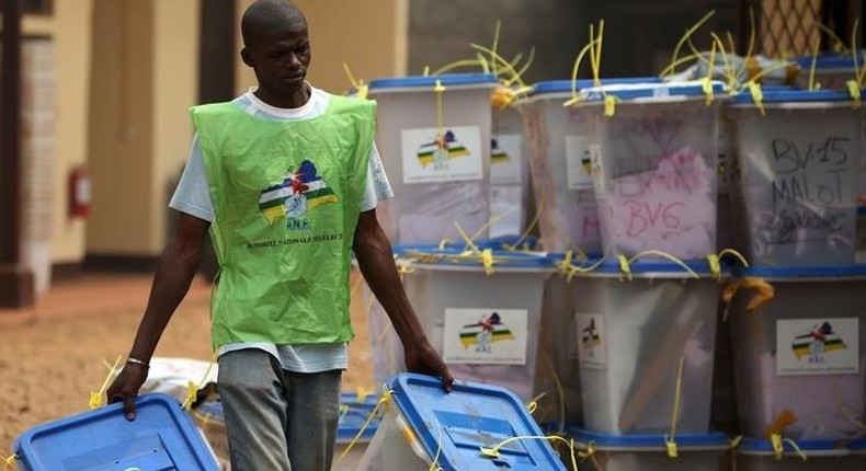 An electoral official carries ballot boxes in a warehouse used as an official centre used to keep votes from the last second round of presidential and legislative elections, Bangui, Central African Republic, February 16, 2016. REUTERS/Siegfried Modola