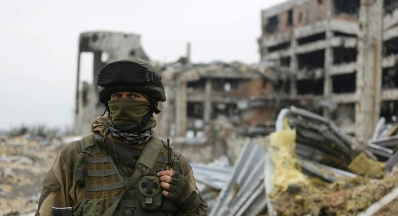 An armed pro-Russian separatist of the self-proclaimed Donetsk People's Republic (DNR) stands in front of the destroyed Donetsk International Airport in Donetsk, eastern Ukraine, on June 1, 2016