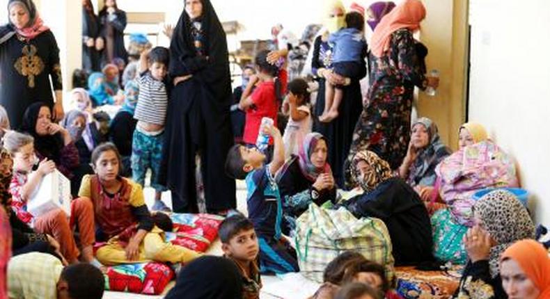 Civilians who fled their homes due to clashes on the outskirts of Falluja, gather in the town of Garma, Iraq.