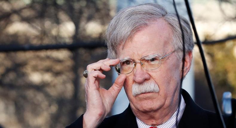 FILE - In this March 5, 2019 file photo, national security adviser John Bolton adjusts his glasses before an interview at the White House in Washington.  (AP Photo/Jacquelyn Martin)