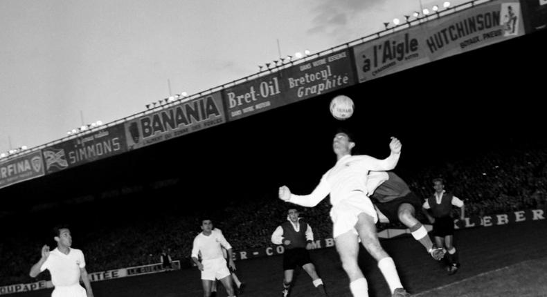 First to the ball: Raymond Kopa of Real Madrid holds off Michel Leblond of Reims in the first European Cup final in Paris in June 1956