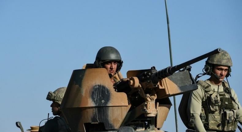 Turkish soldiers stand in a Turkish army tank driving back to Turkey from the Syrian-Turkish border town of Jarabulus on September 2, 2016 in the Turkish-Syrian border town of Karkamis