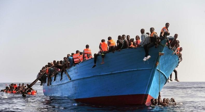 Migrants wait to be rescued in the Mediterranean Sea off the coast of Libya on October 4, 2016