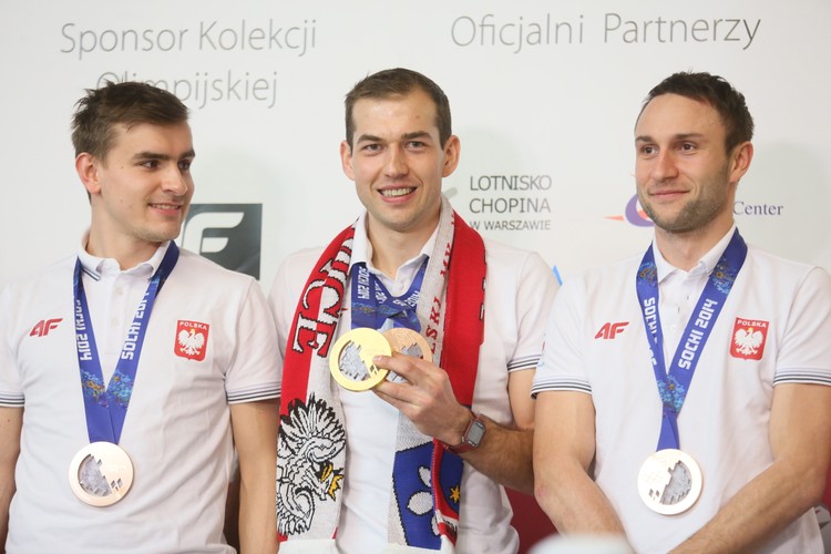 Brązowi medaliści w rywalizacji drużynowej - od lewej: Jan Szymański, Zbigniew Bródka (także złoty krążek na 1500 m) i Konrad Niedźwiecki podczas powitania na lotnisku Okęcie