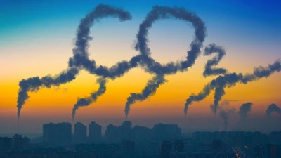 Evening view of the industrial landscape of the city with smoke emissions from chimneys at sunset CO2.