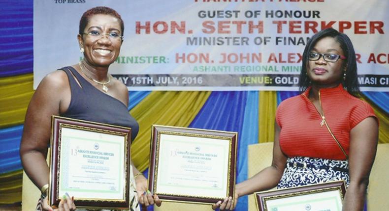 FROM LEFT: NANA EFUA ROCKSON (GROUP HEAD, CORPORATE AFFAIRS & MARKETING FOR GLICO GROUP) DISPLAYING THE AWARDS WITH JENNIFER SIRA DARTEH (BUSINESS DEVELOPMENT OFFICER FOR GLICO GENERAL) 