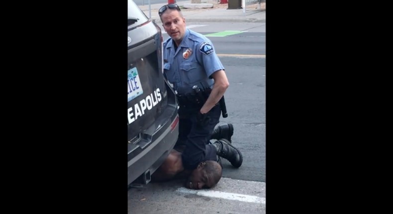 A Minneapolis police officer holds his knee to the neck of George Floyd, who died in police custody.