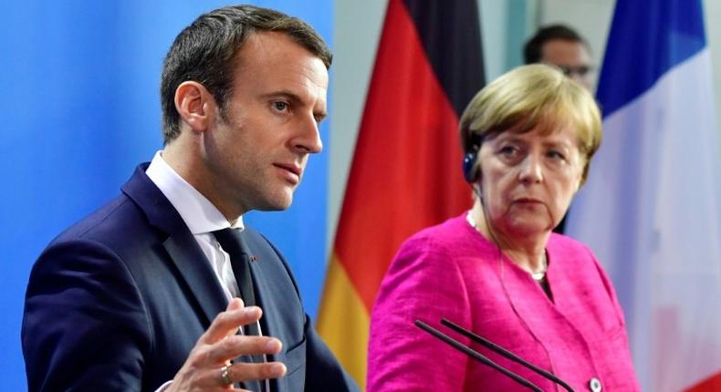 German Chancellor Angela Merkel and French President Emmanuel Macron say they are ready to change EU treaties if necessary