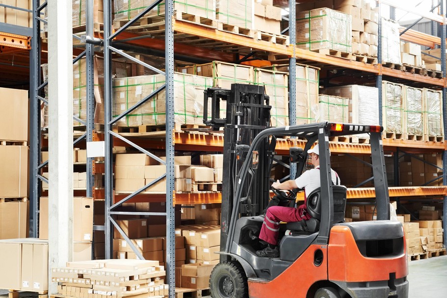 worker driver at warehouse forklift loader works