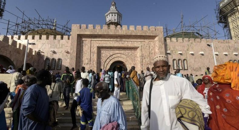 Members of the Mouride Brotherhood, a large Sufi order largely present in Senegal, queue to enter the Great Mosque in Touba on November 19, 2016