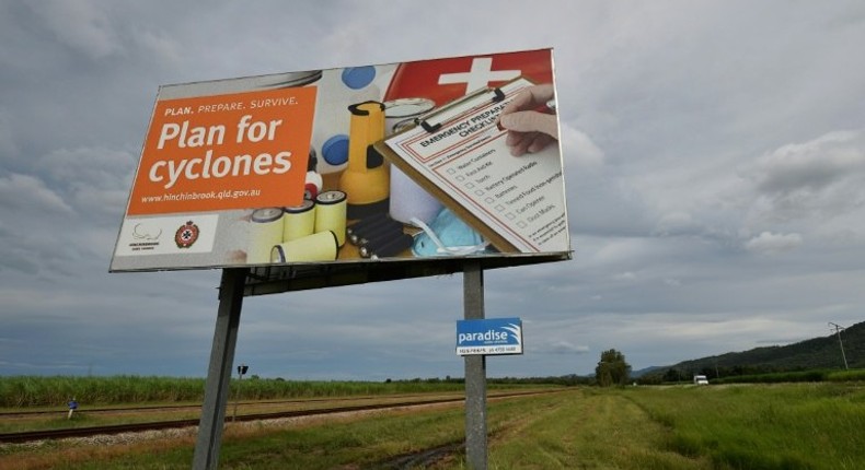 A warning sign is seen outside the city of Townsville in far north Queensland, where thousands of people are being evacuated as Cyclone Debbie approaches