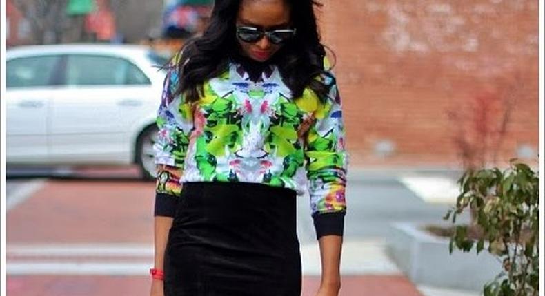 Monica looks great in this floral blouse and corduroy skirt