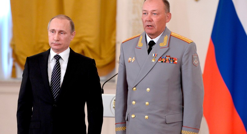 Russian President Vladimir Putin, left, poses with Col. Gen. Alexander Dvornikov, right, during an awarding ceremony in Moscow's Kremlin, Russia on March 17, 2016.