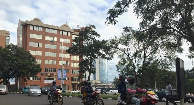 Commuters use motorcycle taxis to make their way through early morning traffic in the Rwanda's capital Kigali, May 11, 2016. 