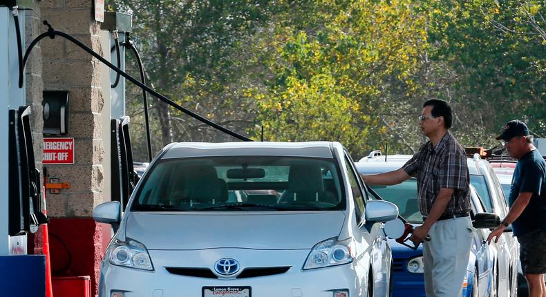 People fill up their tanks with gasoline at a Costco Gas Station in Carlsbad, California.